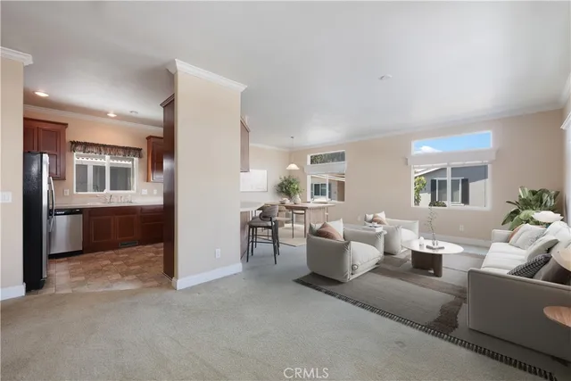 a living room with furniture and view of kitchen