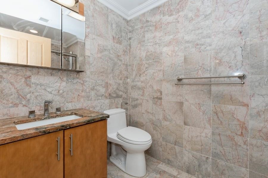 17 Meadow Road, Unit 407 Rutherford, NJ 07070 - Photo 15 of 21 a bathroom with a toilet sink and mirror