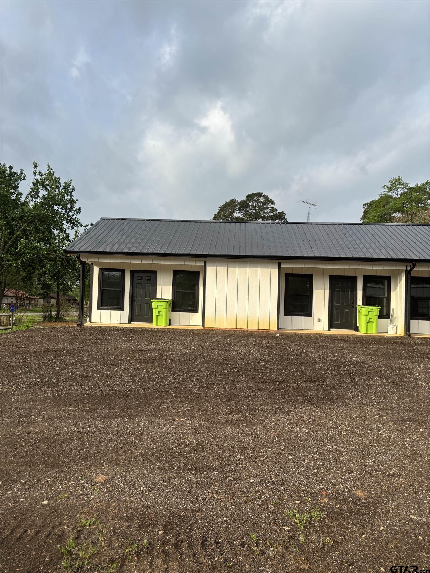 11571 19th Avenue, Unit 103 Tyler, TX 75708 - Photo 1 of 4 a front view of house with yard