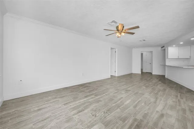 a view of a kitchen with microwave and a ceiling fan