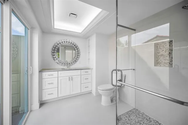 a spacious bathroom with a toilet a sink and a mirror