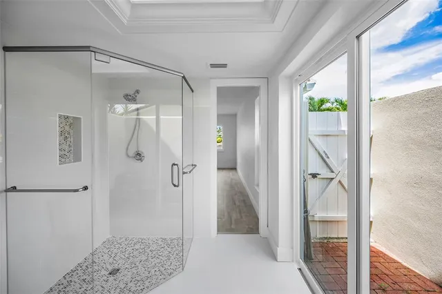 a bathroom with a shower and a sink