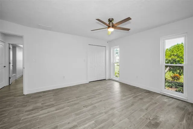 wooden floor in an empty room with a window