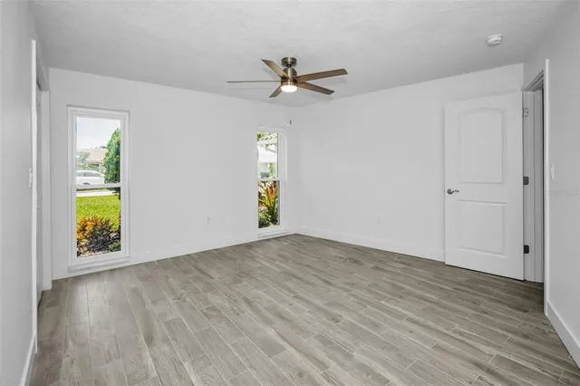 wooden floor in an empty room with a window