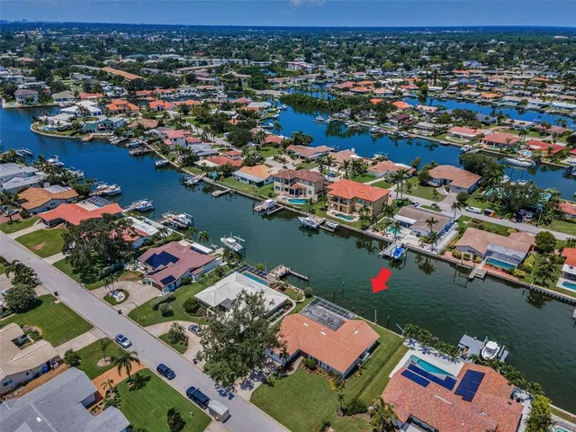 an aerial view of lake and residential houses with outdoor space