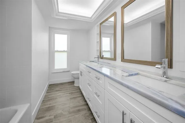 a bathroom with a double vanity sink and a mirror