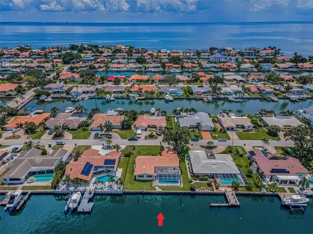 an aerial view of a houses with a parking space