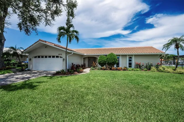 a front view of a house with a garden and plants