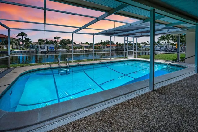 a view of a backyard with a swimming pool