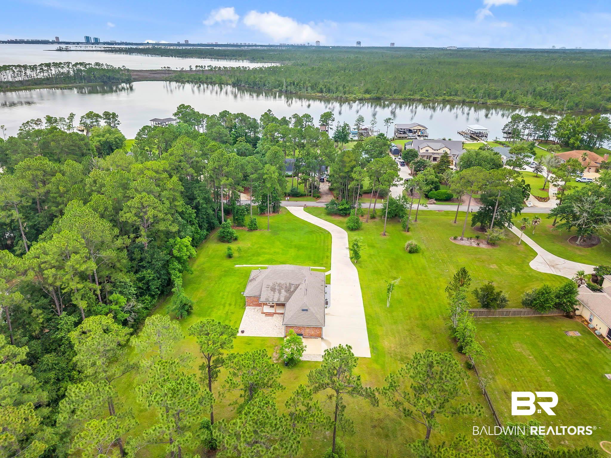 8145 Bay View Drive Foley, AL 36535 - Photo 70 of 81 Aerial view of a nearby body of water and a heavily wooded area