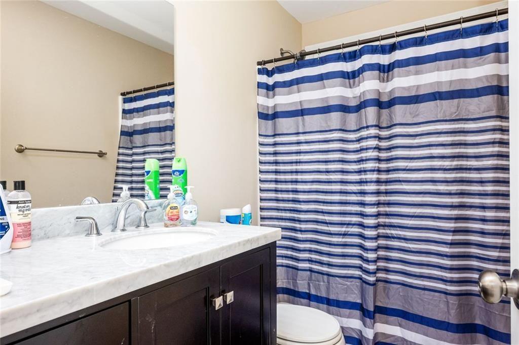 2020 Youngstown Place Powder Springs, GA 30127 - Photo 19 of 25 a bathroom with a sink and a mirror