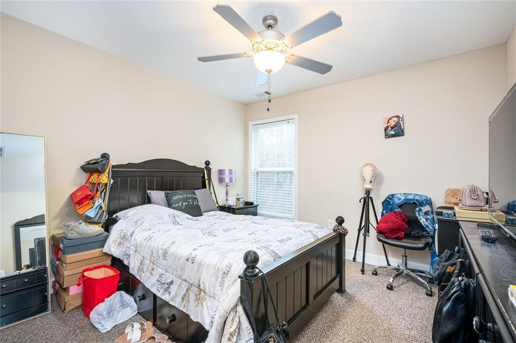 2020 Youngstown Place Powder Springs, GA 30127 - Photo 20 of 25 a bedroom with a bed and a chandelier