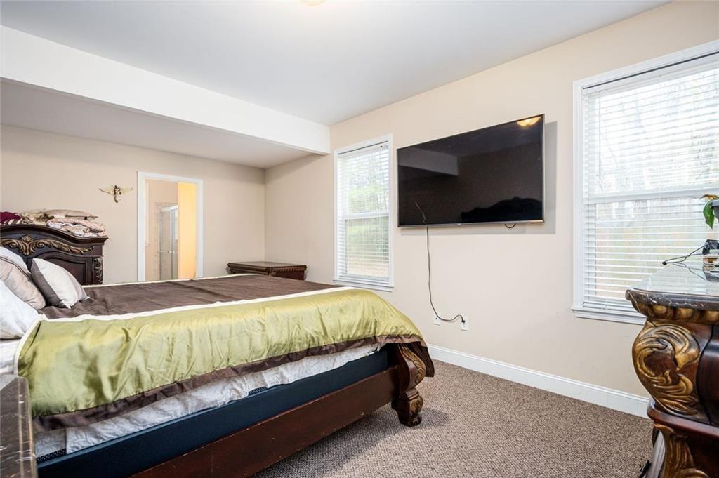 2020 Youngstown Place Powder Springs, GA 30127 - Photo 7 of 25 a bedroom with a bed and a flat screen tv