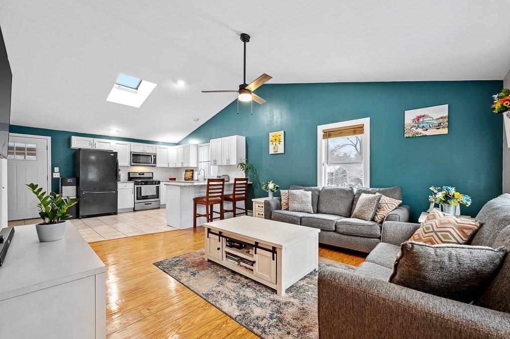183 Freeman Road Charlton, MA 01507 - Photo 3 of 26 a living room with furniture kitchen view and a chandelier