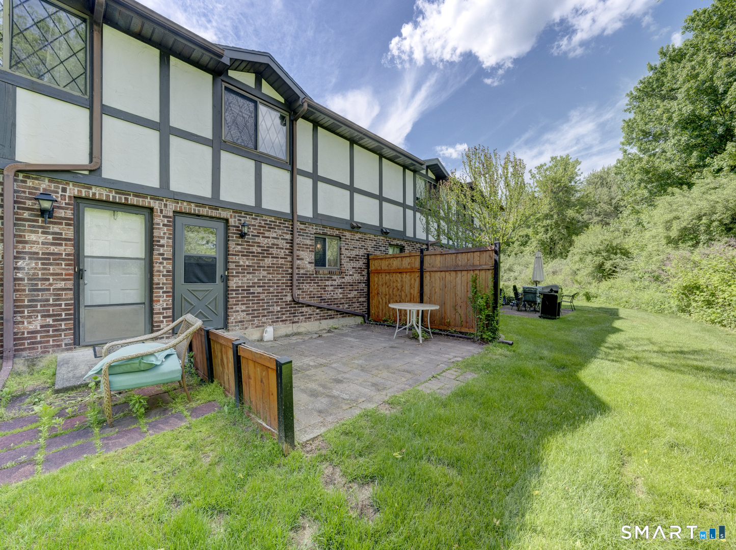 2 Branch Road, Unit 2C Thomaston, CT 06787 - Photo 20 of 26 a backyard of a house with outdoor seating