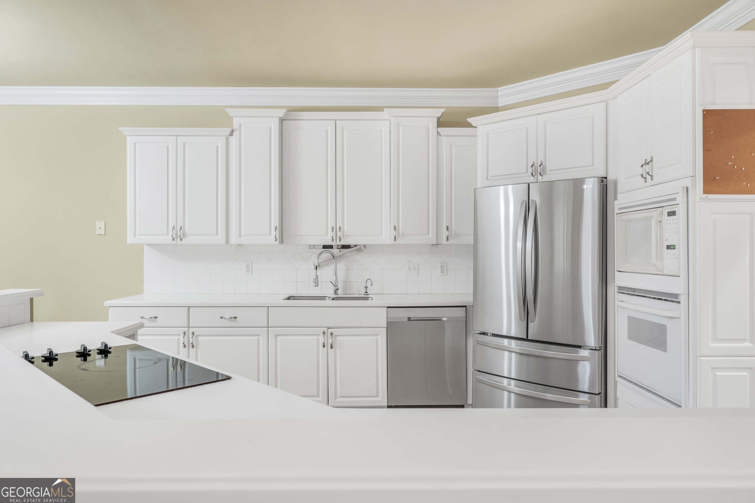 3003 Southwest East Fairview Road McDonough, GA 30252 - Photo 12 of 48 a kitchen with a refrigerator sink and cabinets