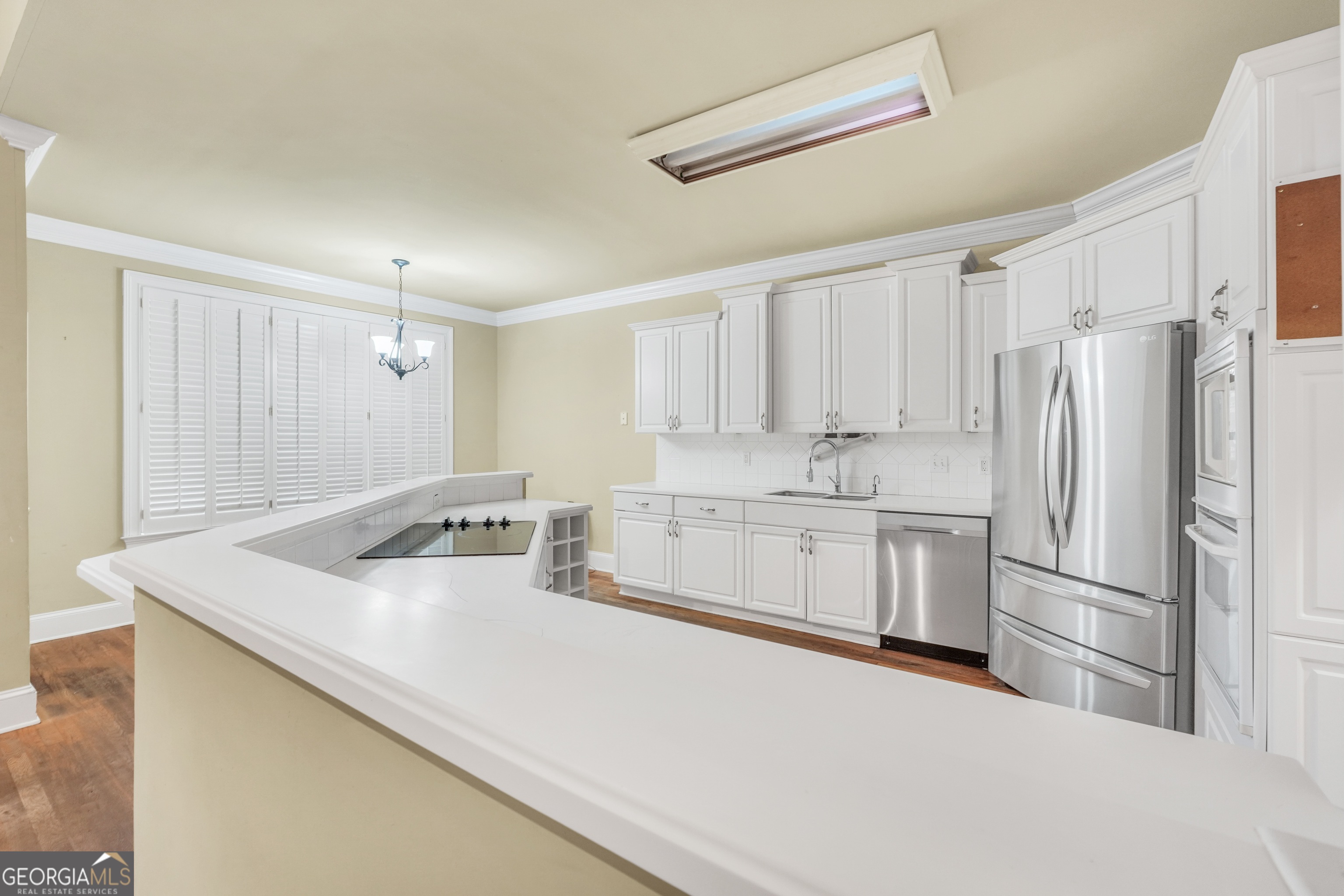 3003 Southwest East Fairview Road McDonough, GA 30252 - Photo 13 of 48 a kitchen with stainless steel appliances granite countertop a refrigerator sink and white cabinets