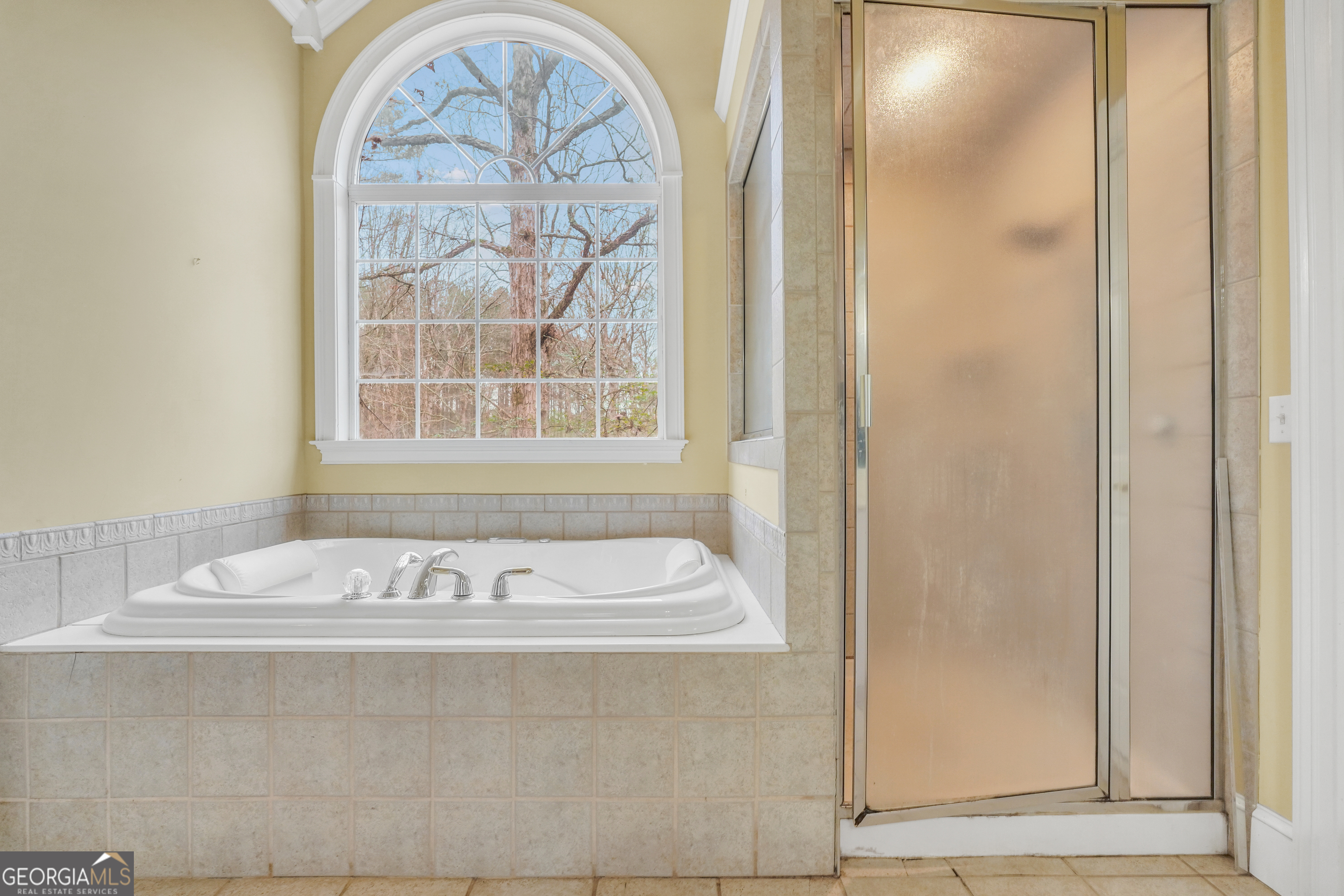 3003 Southwest East Fairview Road McDonough, GA 30252 - Photo 34 of 48 a bathroom with a bathtub and a window