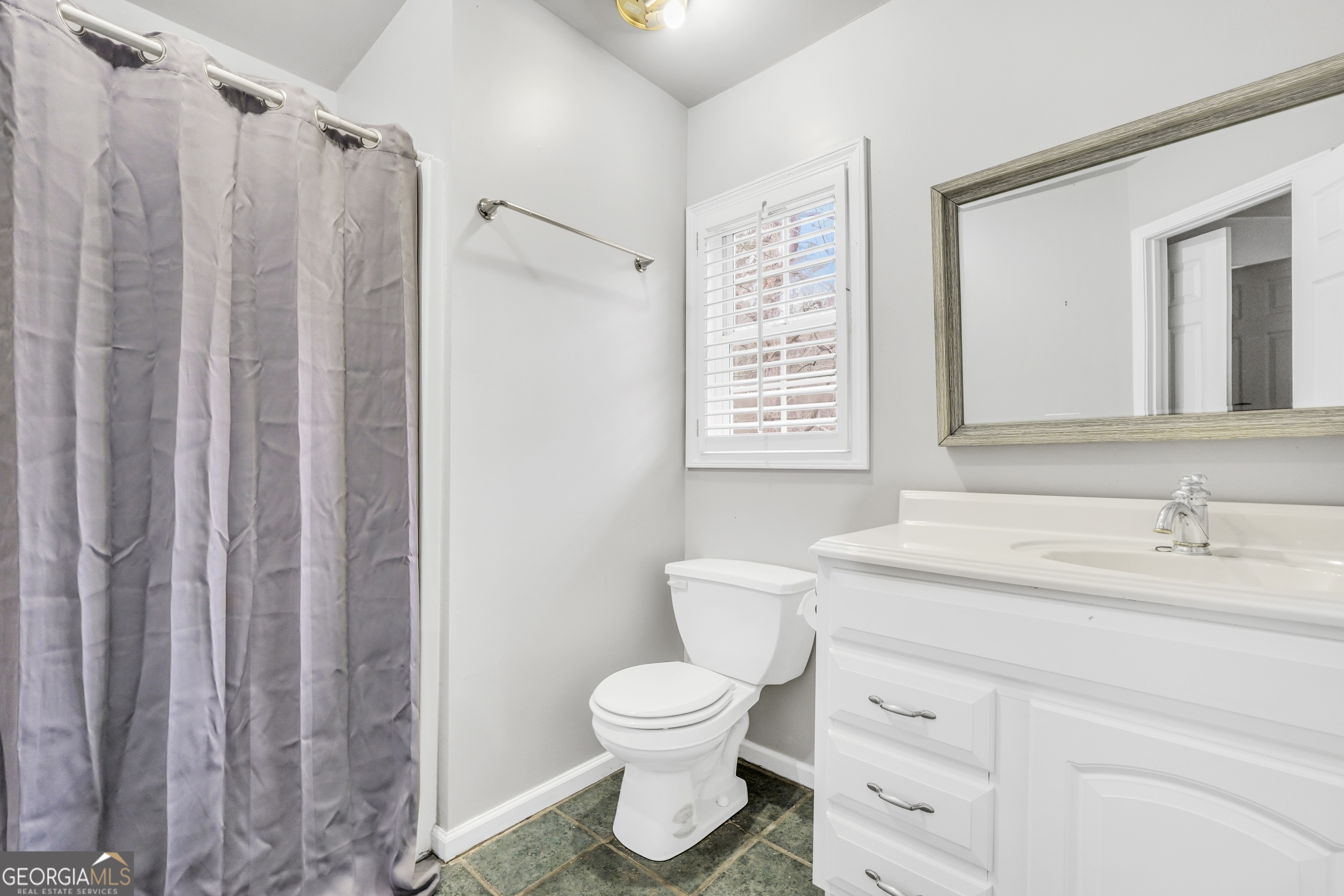 3003 Southwest East Fairview Road McDonough, GA 30252 - Photo 40 of 48 a bathroom with a toilet sink and a mirror