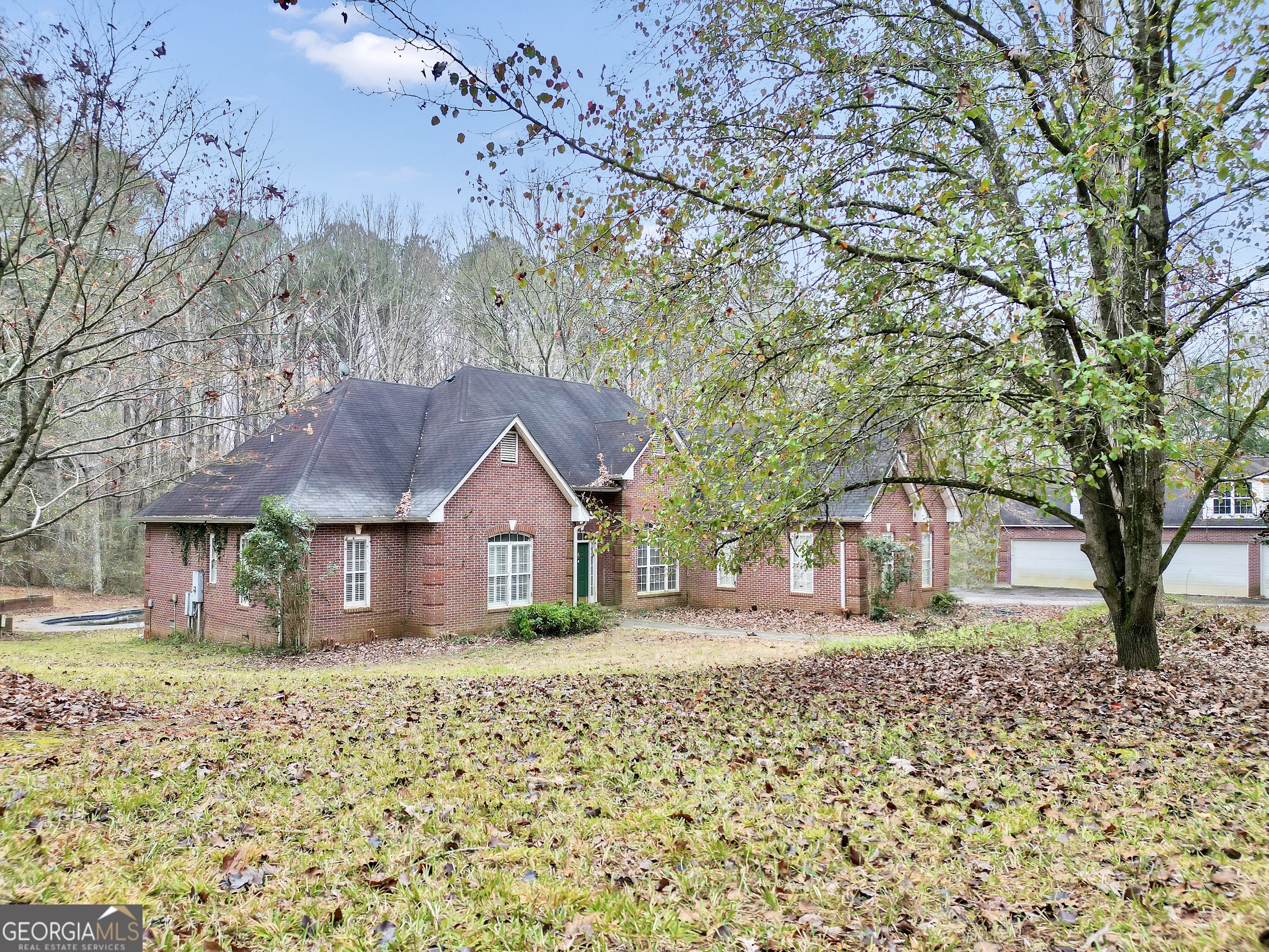 3003 Southwest East Fairview Road McDonough, GA 30252 - Photo 4 of 48 a front view of a house with a yard