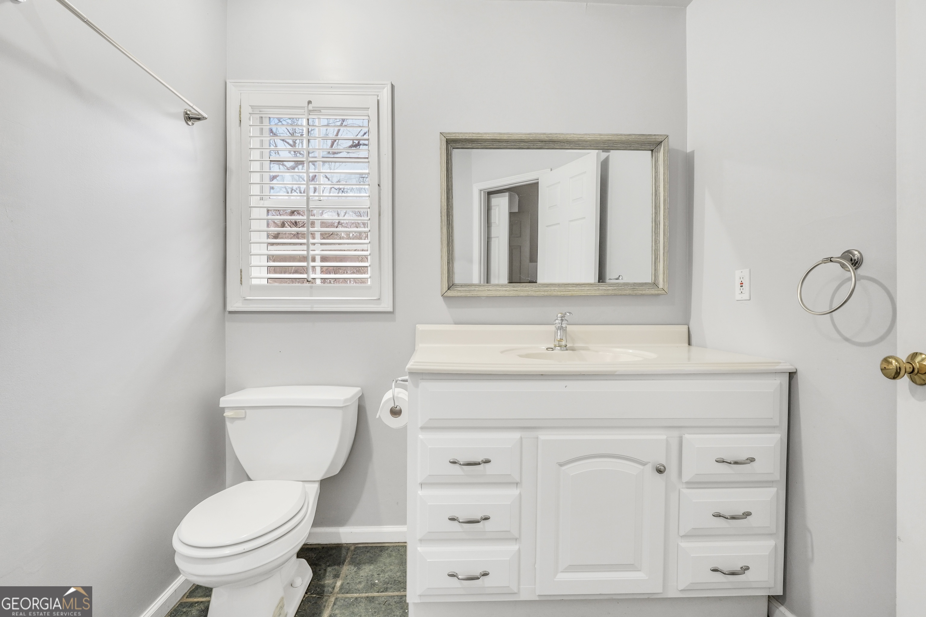 3003 Southwest East Fairview Road McDonough, GA 30252 - Photo 41 of 48 a bathroom with a toilet a sink and mirror
