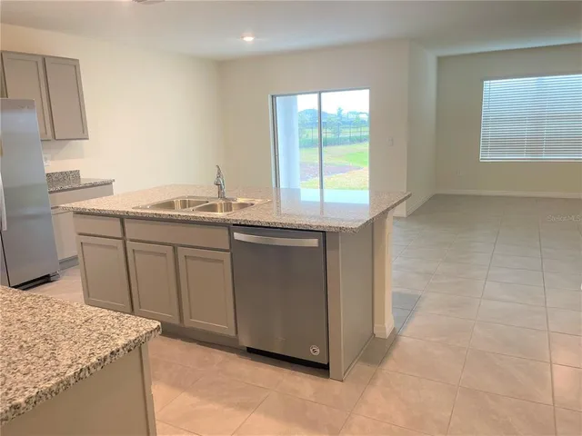 a kitchen with a sink cabinets and window