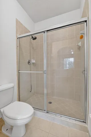 a bathroom with a shower and a toilet