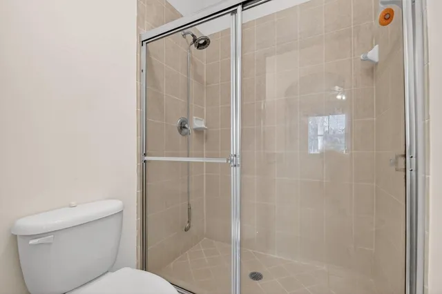 a bathroom with a shower and toilet