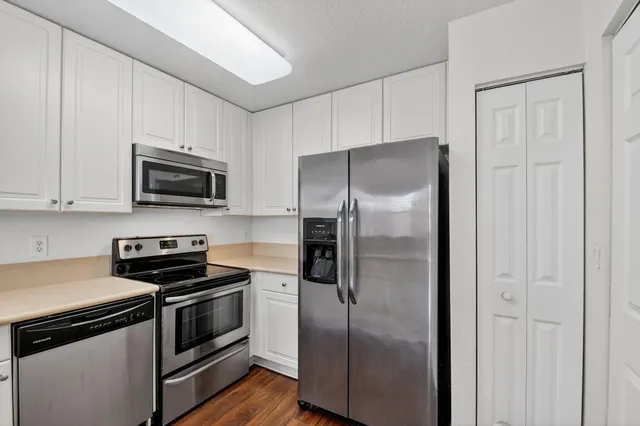 a kitchen with a refrigerator stove and microwave
