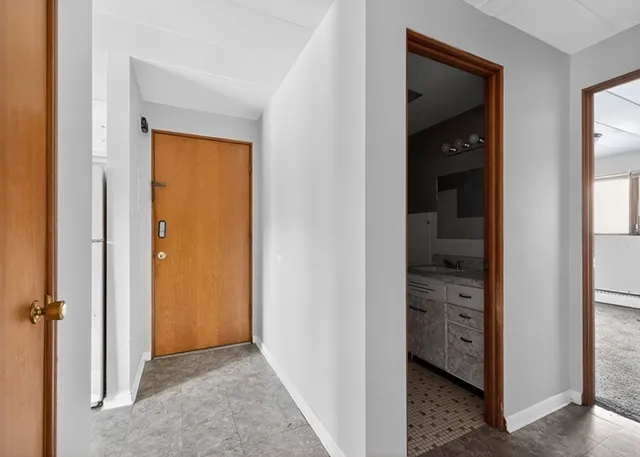 a kitchen with white cabinets and white appliances
