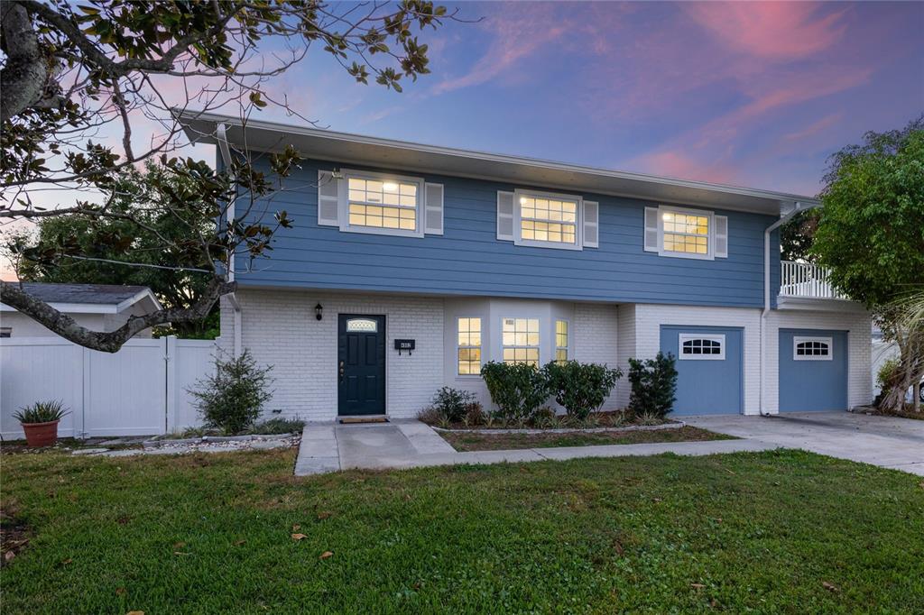a front view of a house with a yard and garage