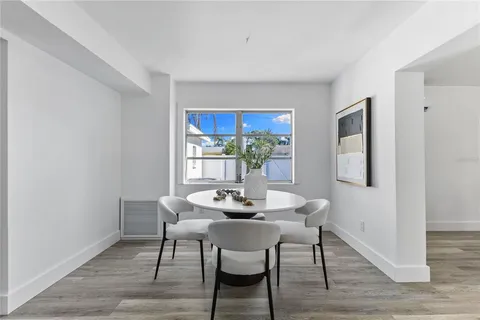 a dining room with furniture and wooden floor