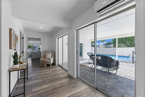 a living room with furniture and large windows