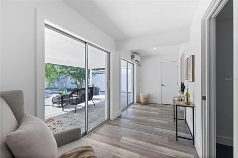 a view of a patio with table and chairs and potted plants