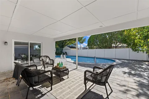 a view of a patio with table and chairs and potted plants