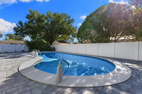 a view of a swimming pool with a lounge chair