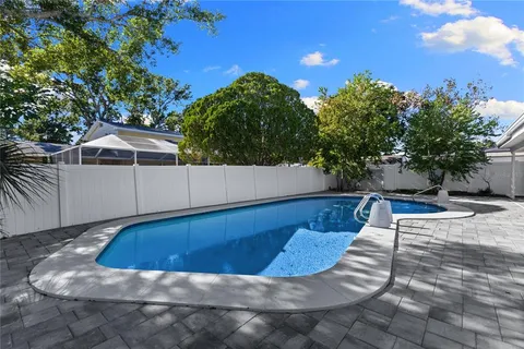 a view of a house with backyard and sitting area