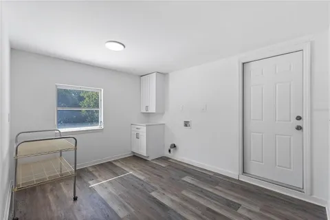 a view of empty room with wooden floor and cabinet