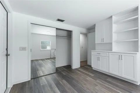 an empty room with windows and closet