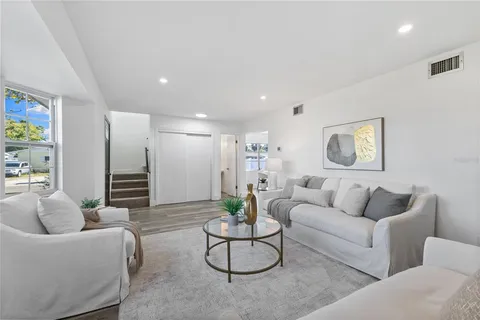a living room with furniture and white walls