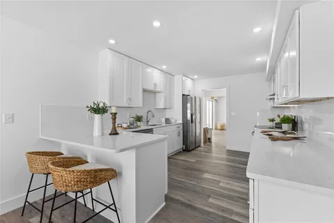 a kitchen with stainless steel appliances kitchen island granite countertop a sink and cabinets
