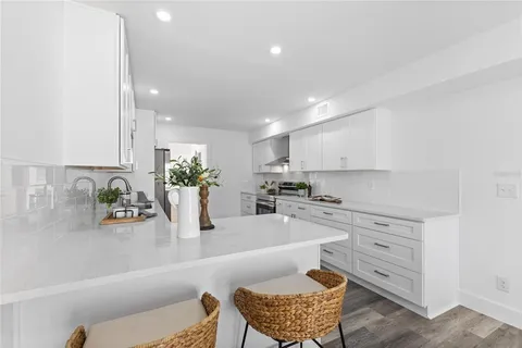 a kitchen with a table and chairs in it