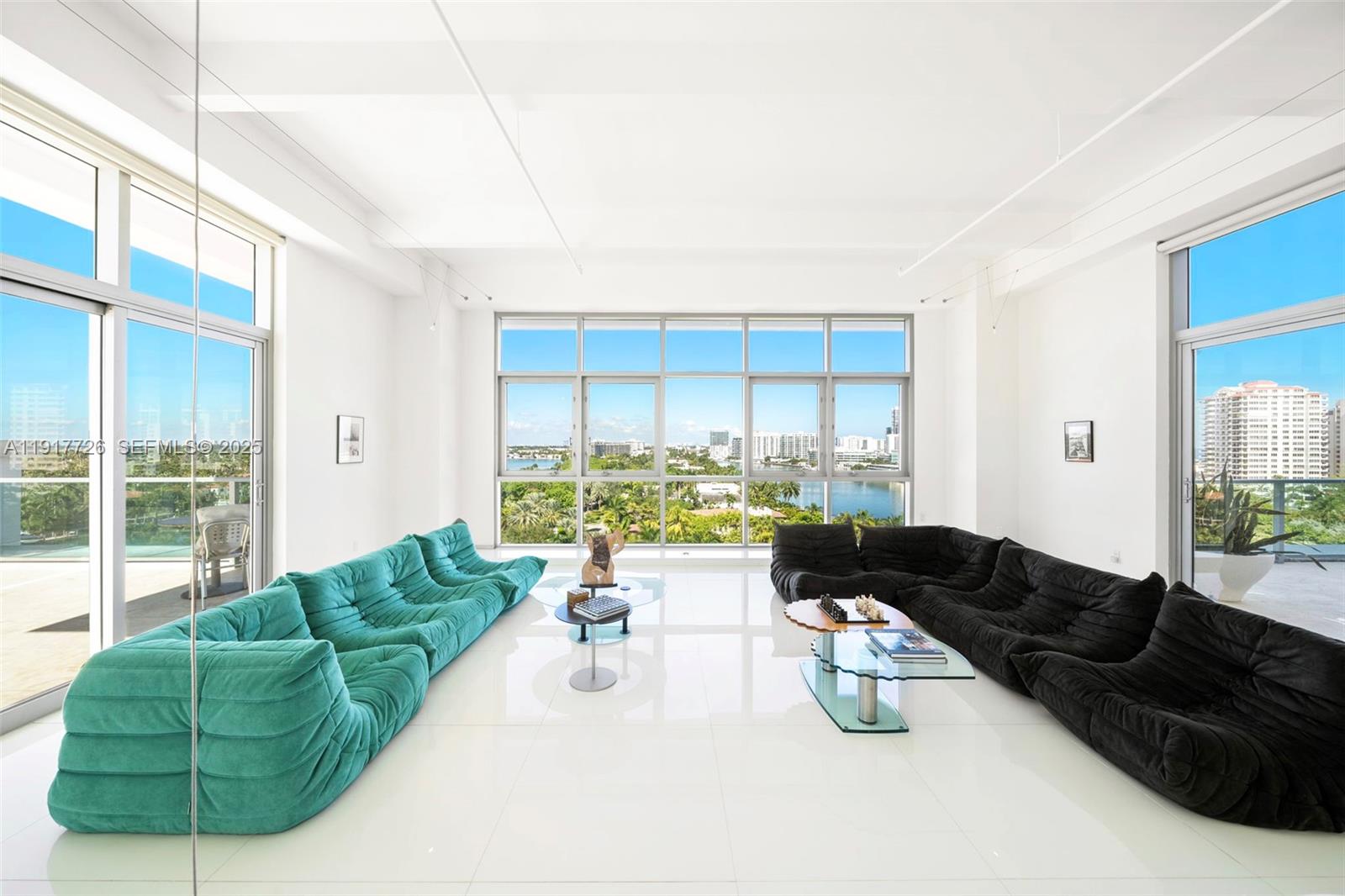 201 Aqua Avenue, Unit 801 Miami Beach, FL 33141 - Photo 2 of 49 a living room with furniture and a large window