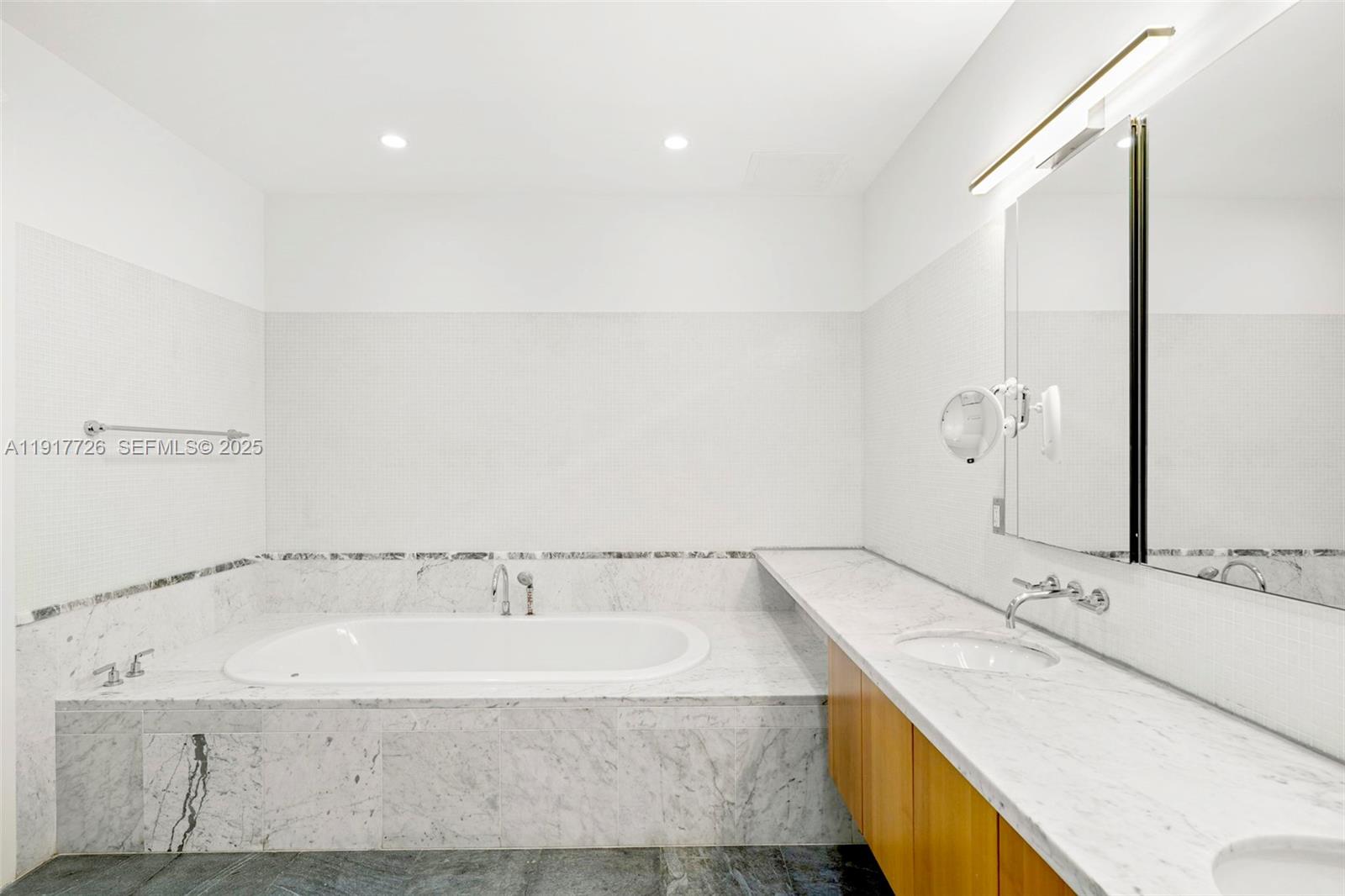 201 Aqua Avenue, Unit 801 Miami Beach, FL 33141 - Photo 26 of 49 a bathroom with a granite countertop sink and a bathtub