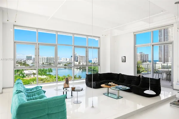 a view of a roof deck with couches and sky view