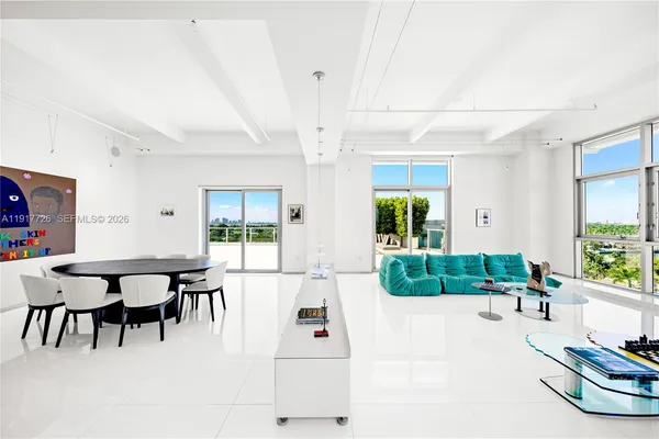 a living room with furniture and a dining table