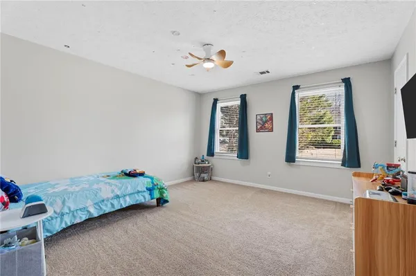 a bedroom with furniture and a flat screen tv