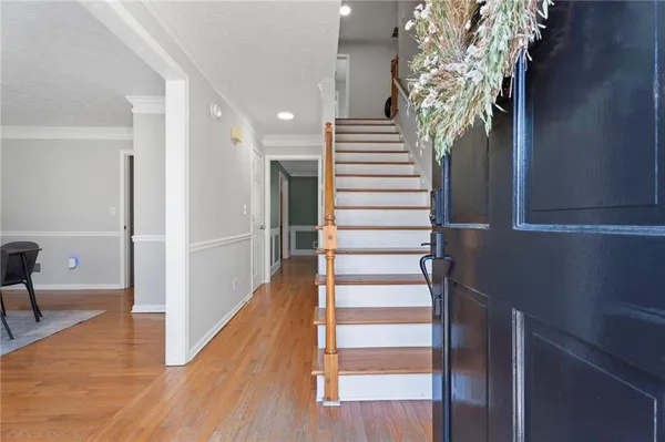 a view of an entryway with wooden floor