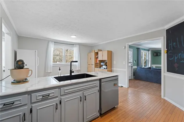 a kitchen with stainless steel appliances a refrigerator and a stove top oven