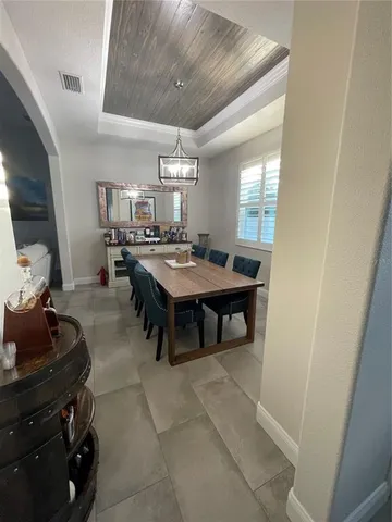 a room with a table chairs and a stove